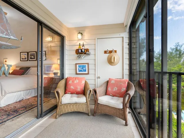 a balcony with chairs and a table