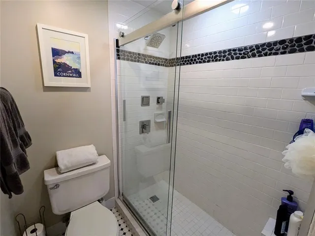 a bathroom with a toilet and a shower