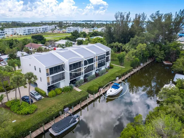 an aerial view of a house with a garden and lake view