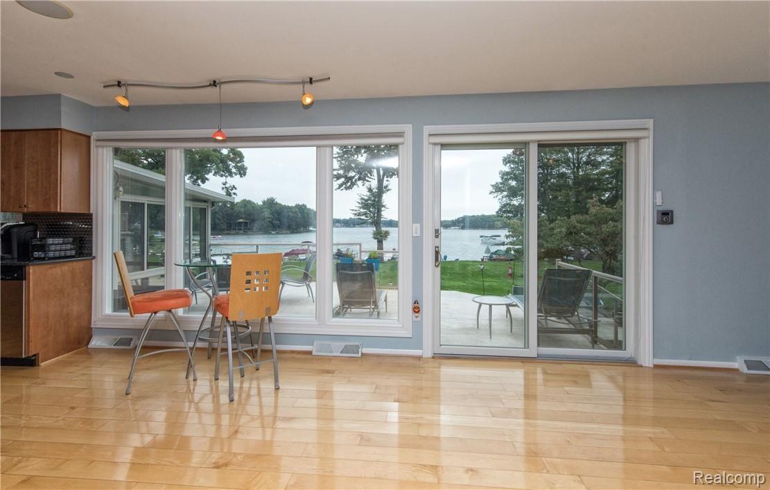 7272 Hatchery Road Waterford, MI 48327 - Photo 8 of 46 Amazing floor to ceiling windows and doorway leading to Dura Deck.