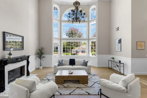 a living room with fireplace furniture and a wooden floor