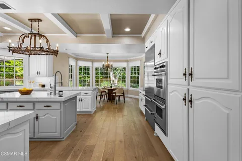 a bathroom with a granite countertop sink and a refrigerator