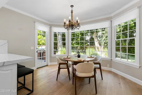 a bathroom with a granite countertop toilet a sink and a mirror