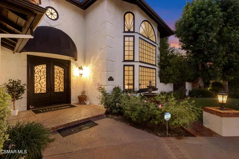 a view of a patio with a table and chairs and potted plants