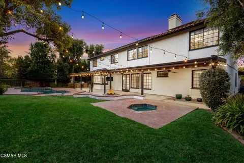 a front view of a house with a yard table and chairs