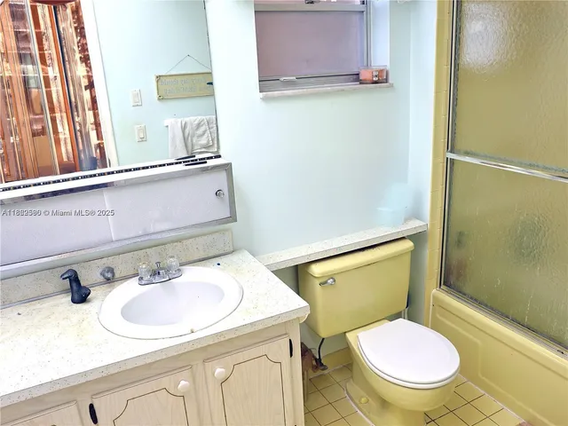 a bathroom with a sink toilet and mirror