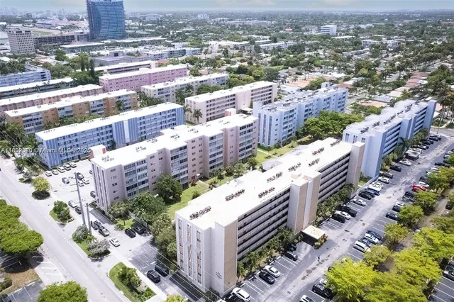 an aerial view of residential houses with yard