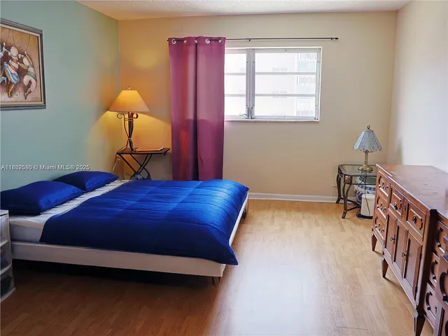 a bed room with a bed and a lamp