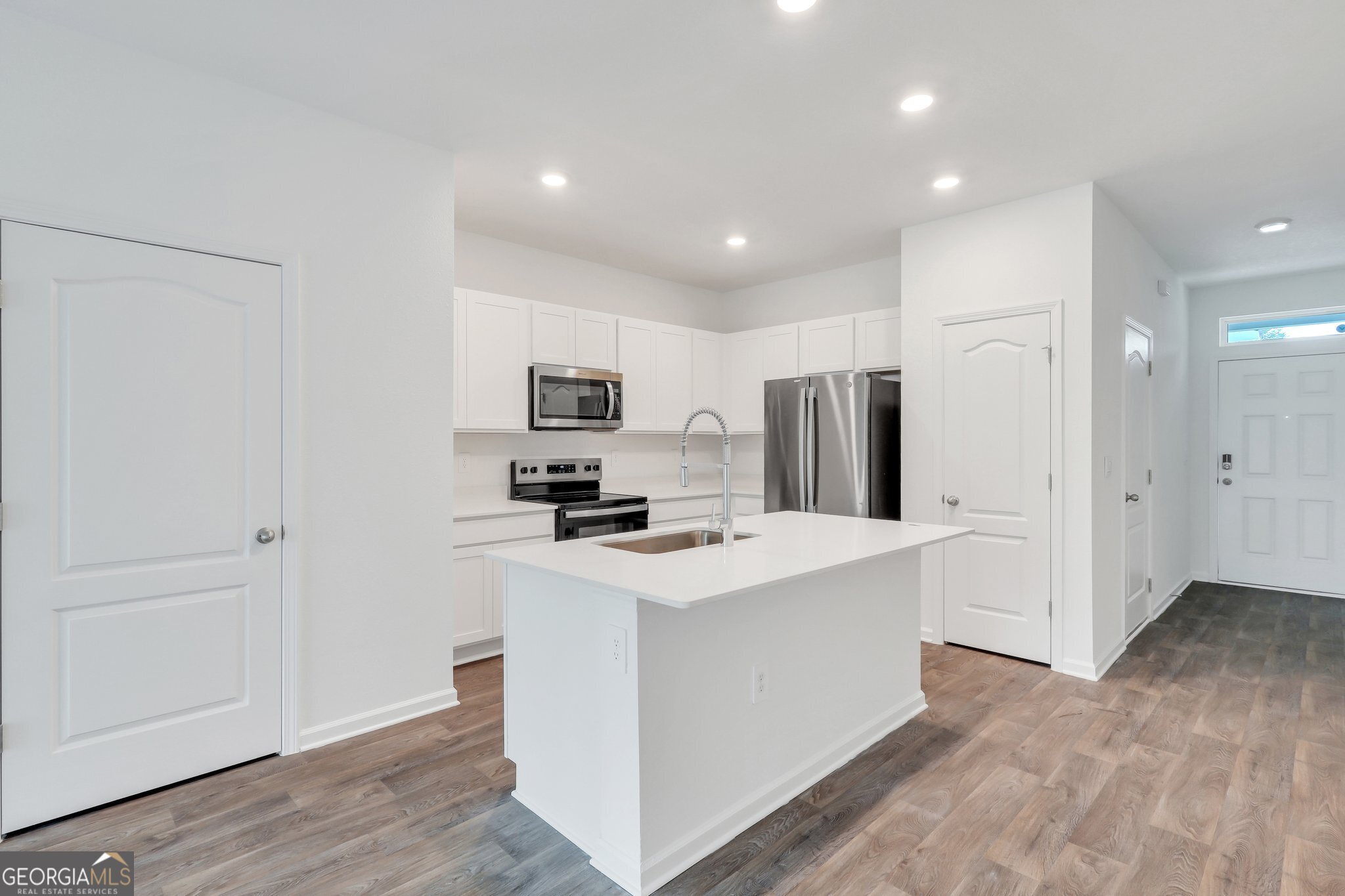 150 Inlet Reach Circle St. Marys, GA 31558 - Photo 7 of 27 a kitchen with stainless steel appliances a refrigerator a stove a sink and white cabinets