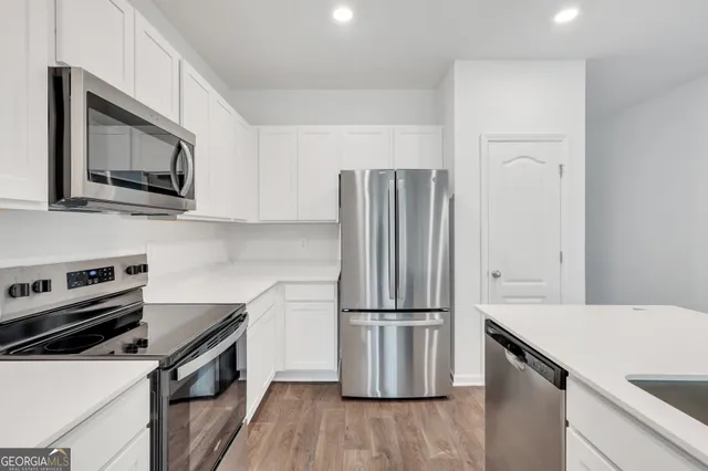 a kitchen with a refrigerator stove and microwave