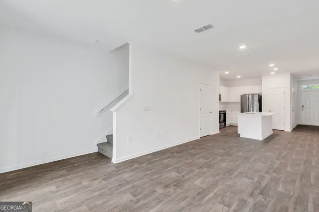 a view of a kitchen with a sink and a refrigerator
