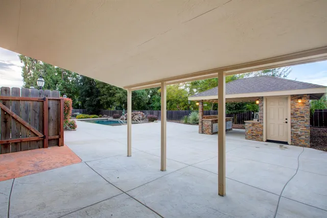 a view of an empty room with a fireplace and a window