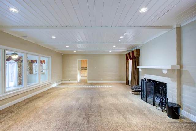 a view of an empty room with a fireplace