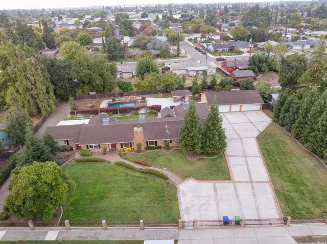an aerial view of residential houses with yard