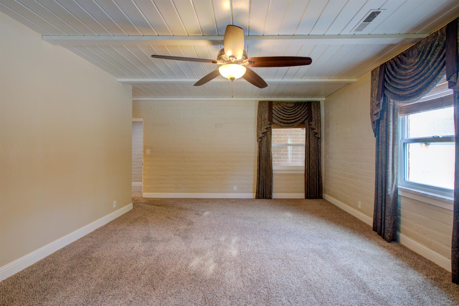 1739 First Street Atwater, CA 95301 - Photo 33 of 58 an empty room that has a window and chandelier fan