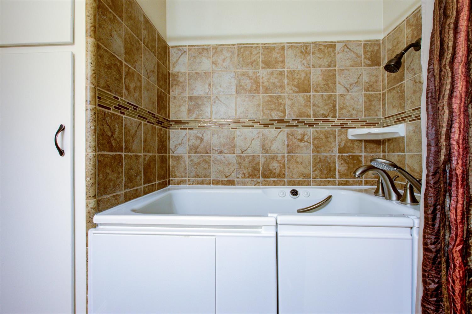 1739 First Street Atwater, CA 95301 - Photo 38 of 58 a bathroom with a tub and shower