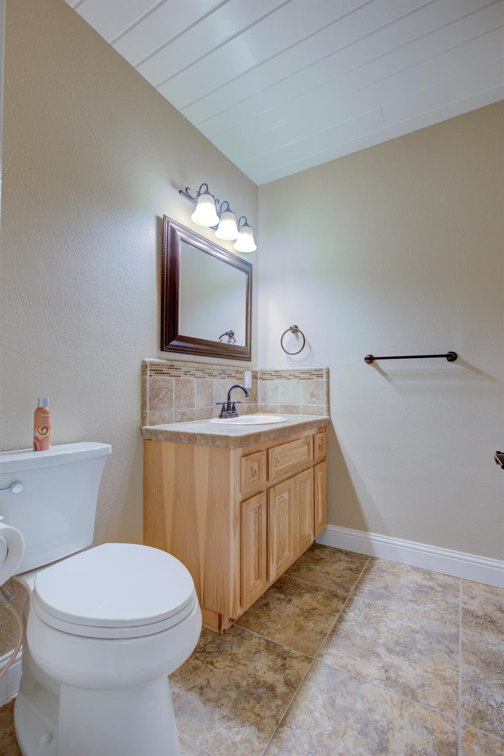 1739 First Street Atwater, CA 95301 - Photo 39 of 58 a bathroom with a sink vanity mirror and toilet