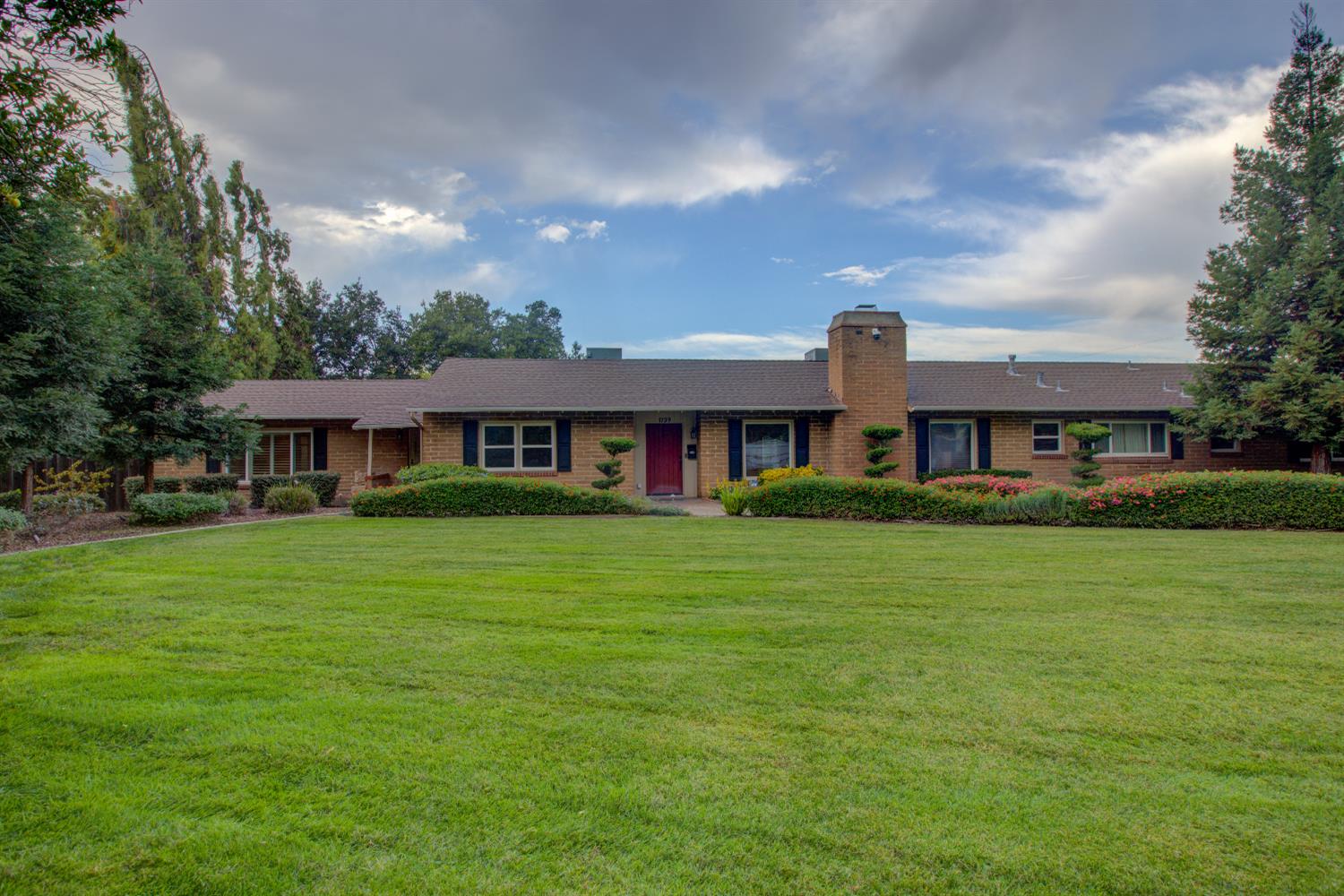 1739 First Street Atwater, CA 95301 - Photo 55 of 58 a front view of a house with a garden
