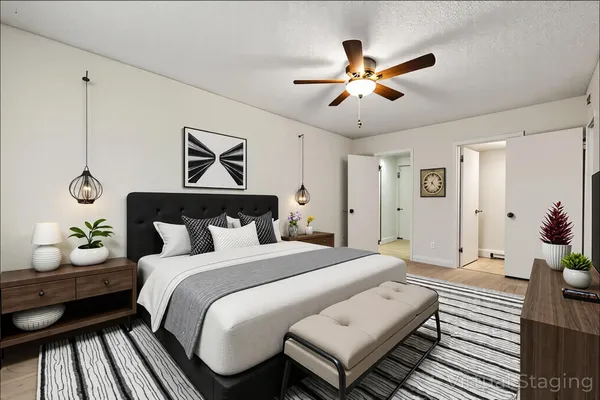 a bedroom with a bed and a chandelier