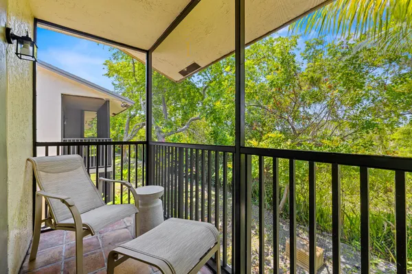 a view of a chair and table in the balcony