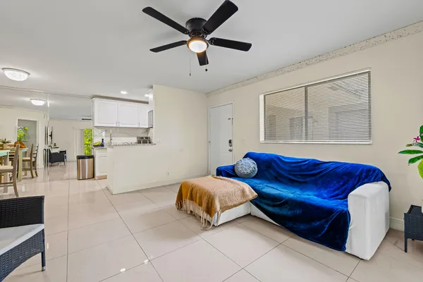 a living room with furniture and kitchen view