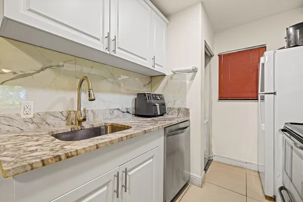 a kitchen with a sink and a refrigerator