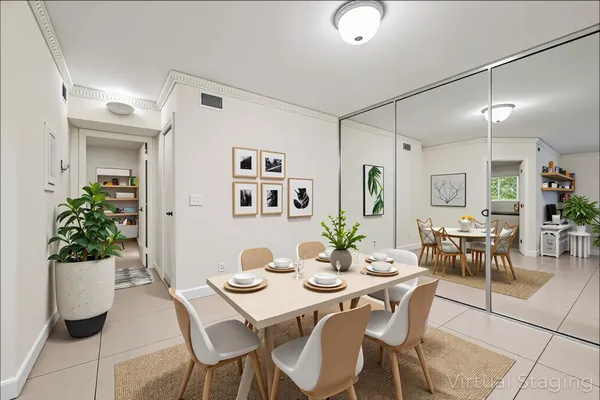 a view of a dining room with furniture and potted plant