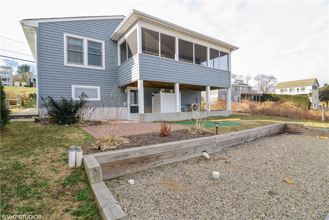 46 Conanicut Road Narragansett, RI 02882 - Photo 24 of 36 Water-view side of house with screened-in porch and outdoor shower with hot and cold running water.