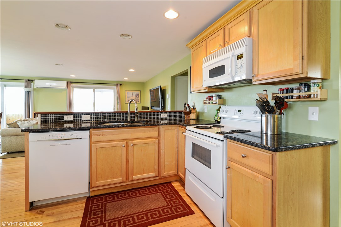 46 Conanicut Road Narragansett, RI 02882 - Photo 9 of 36 The open kitchen, which features granite counter tops, lets the hosts talk with their guests while meals are being prepared.