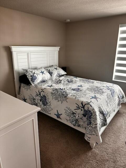 5786 Southeast Edgewater Circle Stuart, FL 34997 - Photo 11 of 15 a bed sitting in a bedroom next to a window