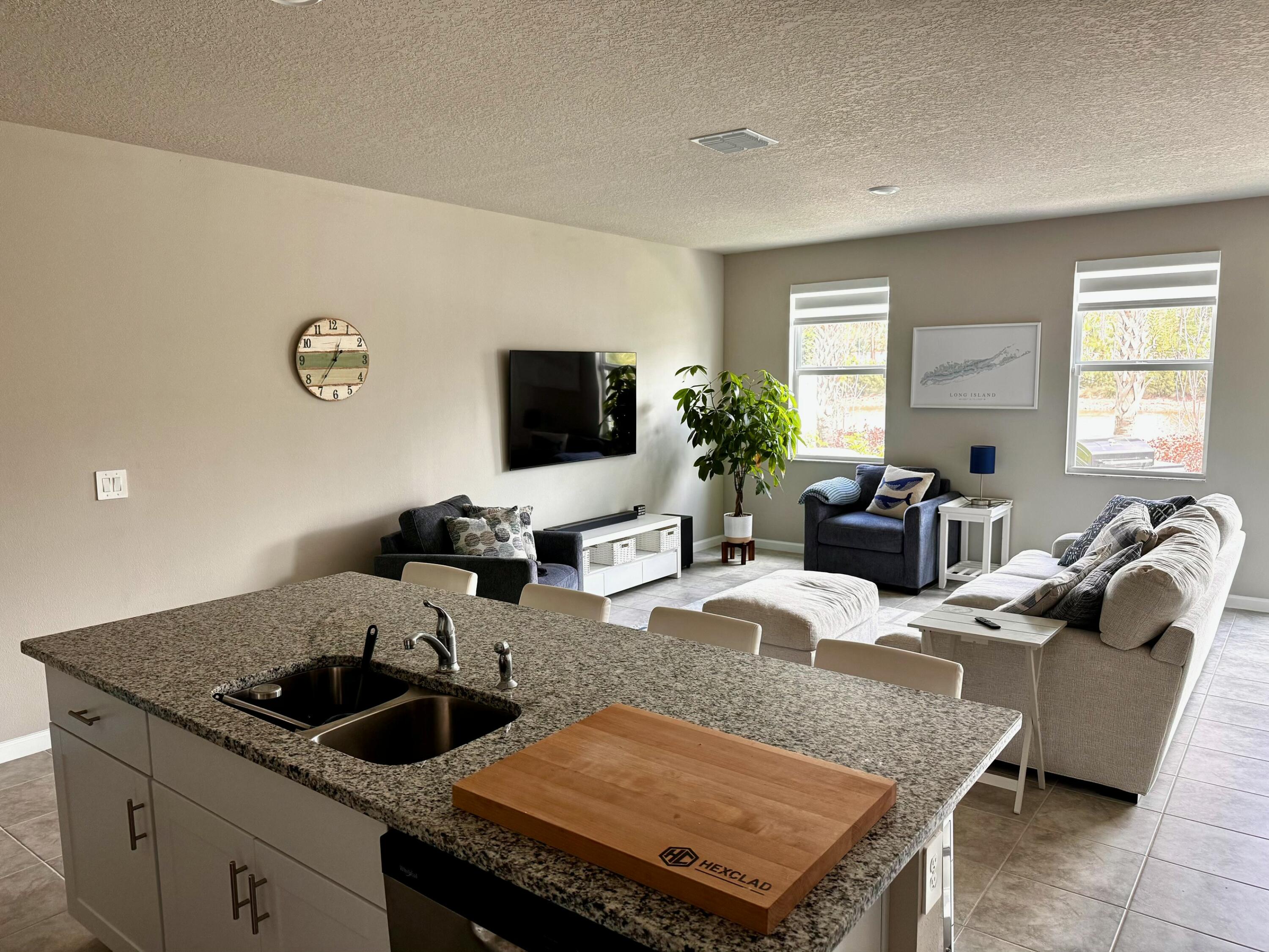 5786 Southeast Edgewater Circle Stuart, FL 34997 - Photo 6 of 15 a living room with furniture and a flat screen tv