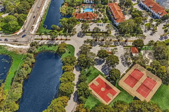 a view of a hallway with dining room and chandelier