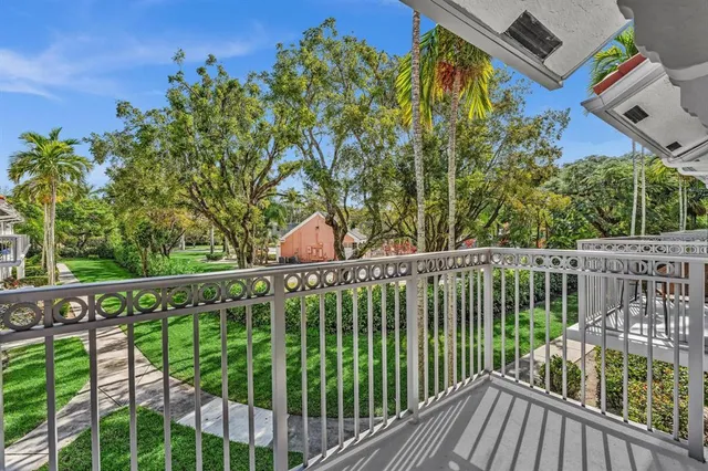 a view of a balcony with iron fence
