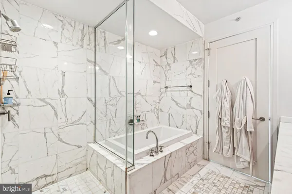 a bathroom with a bathtub and shower