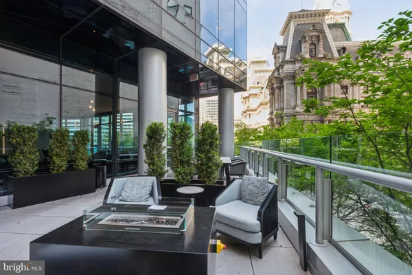 a view of a patio with couches table and chairs and potted plants