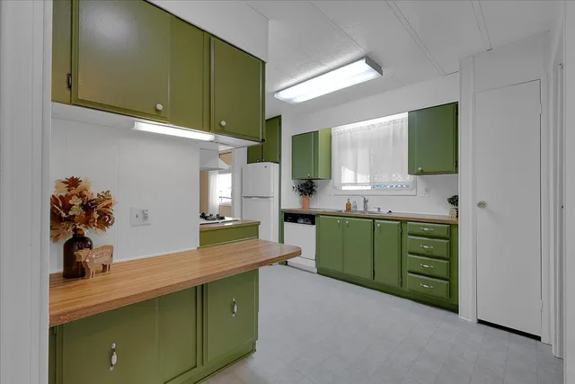 a kitchen with cabinets a sink and a stove