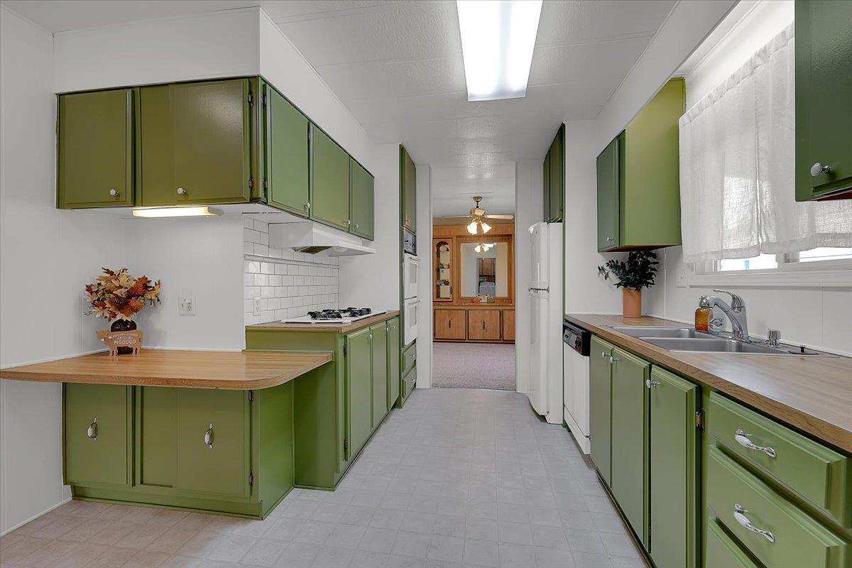 1155 Pease Road, Unit 511 Yuba City, CA 95991 - Photo 12 of 35 a kitchen with cabinets a sink and a stove