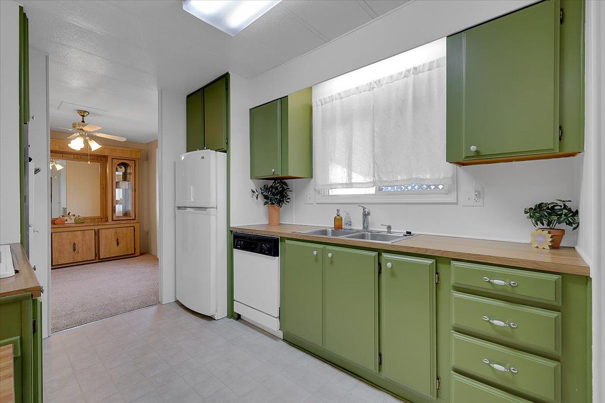 1155 Pease Road, Unit 511 Yuba City, CA 95991 - Photo 13 of 35 a kitchen with a refrigerator and a sink