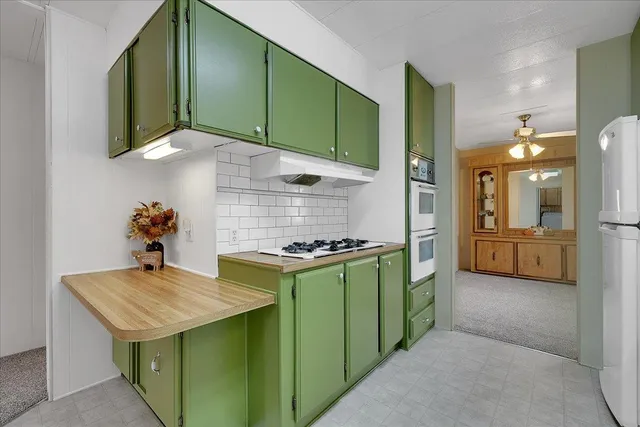 a utility room with stainless steel appliances and cabinets