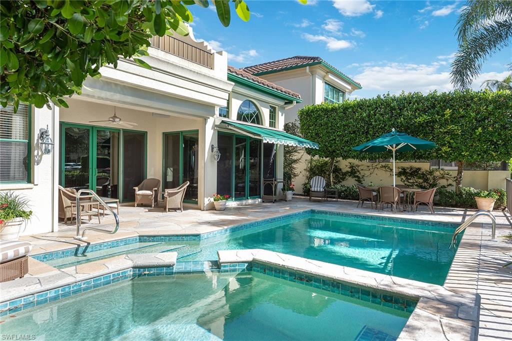 8063 Vizcaya Way Naples, FL 34108 - Photo 1 of 28 a view of a house with swimming pool and sitting area