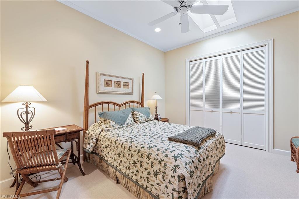 8063 Vizcaya Way Naples, FL 34108 - Photo 13 of 28 a bedroom with a bed and a lamp