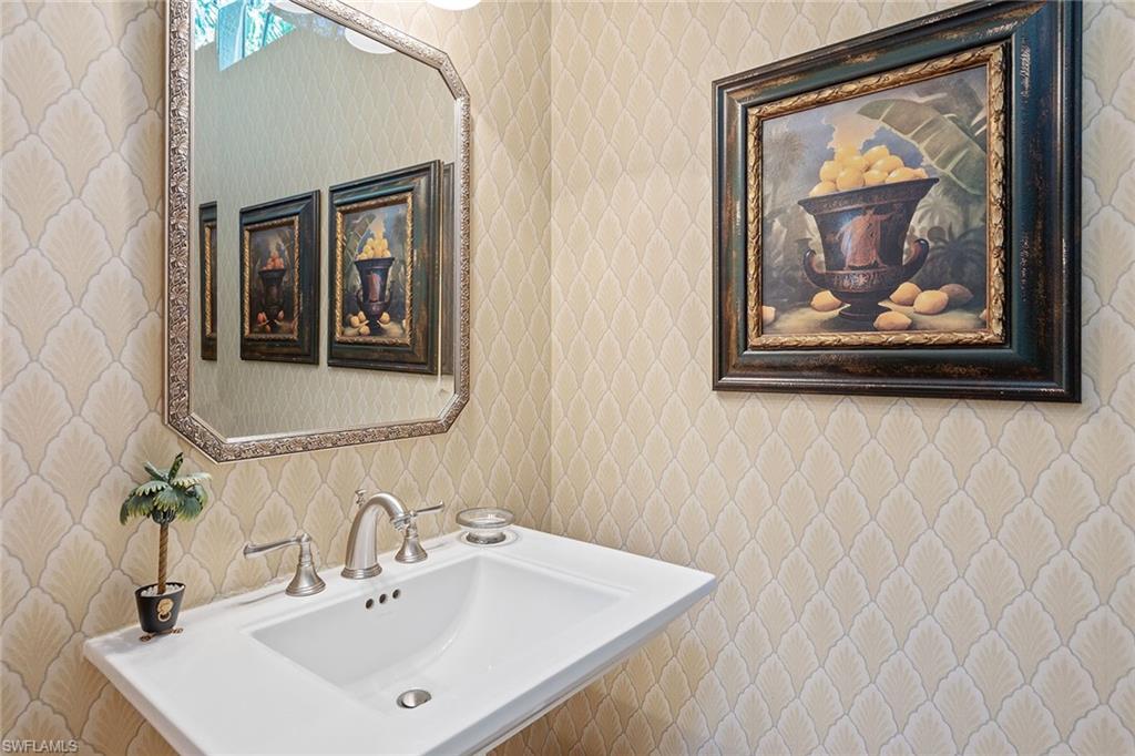 8063 Vizcaya Way Naples, FL 34108 - Photo 20 of 28 a bathroom with a sink and a mirror