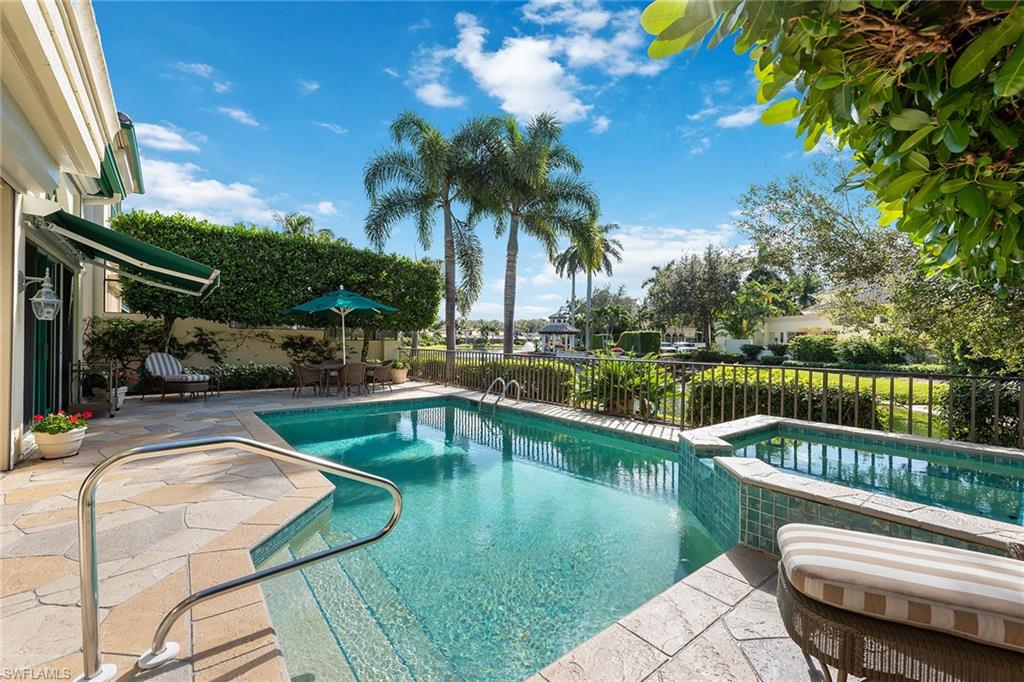 8063 Vizcaya Way Naples, FL 34108 - Photo 24 of 28 a view of a swimming pool with a patio and a garden