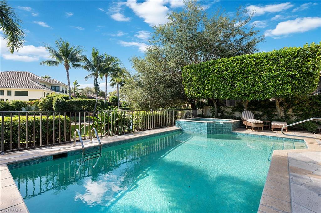 8063 Vizcaya Way Naples, FL 34108 - Photo 25 of 28 a view of a house with swimming pool and sitting area