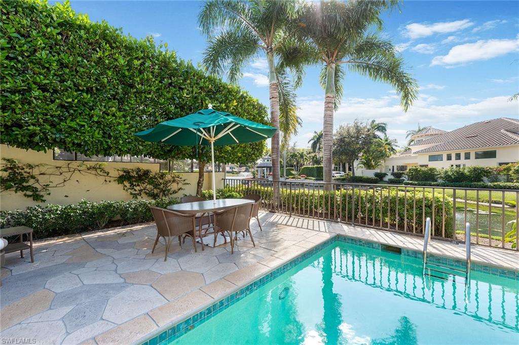 8063 Vizcaya Way Naples, FL 34108 - Photo 26 of 28 a view of a wooden deck with furniture and a yard