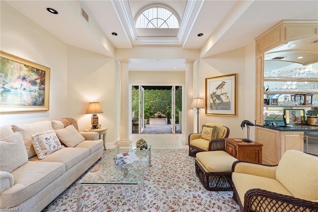 8063 Vizcaya Way Naples, FL 34108 - Photo 5 of 28 a living room with furniture a chandelier and a window