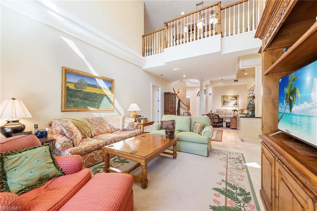 8063 Vizcaya Way Naples, FL 34108 - Photo 6 of 28 a living room with furniture and a flat screen tv