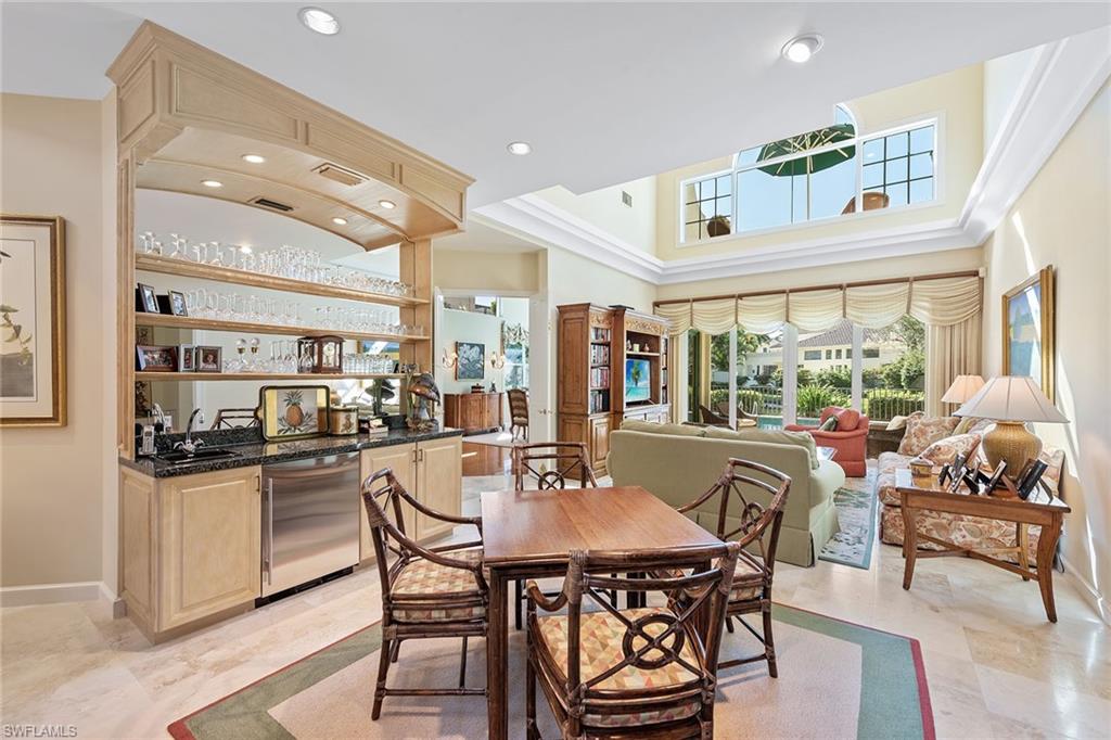 8063 Vizcaya Way Naples, FL 34108 - Photo 10 of 28 a kitchen with a table and chairs in it
