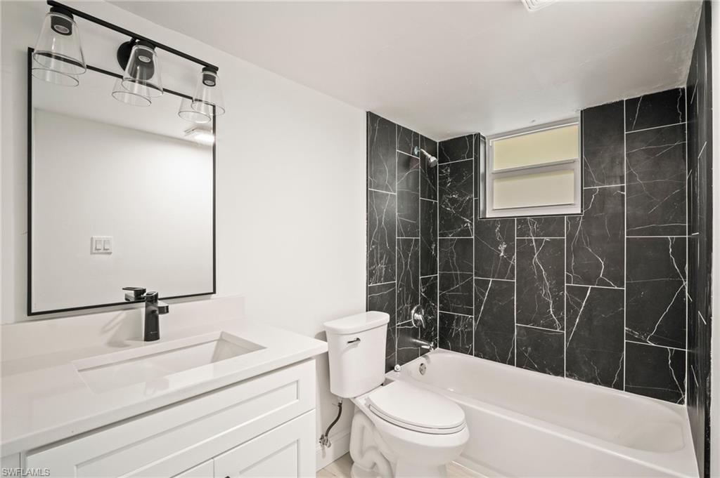 2316 Bayside Street Naples, FL 34112 - Photo 14 of 24 a bathroom with a sink toilet and shower