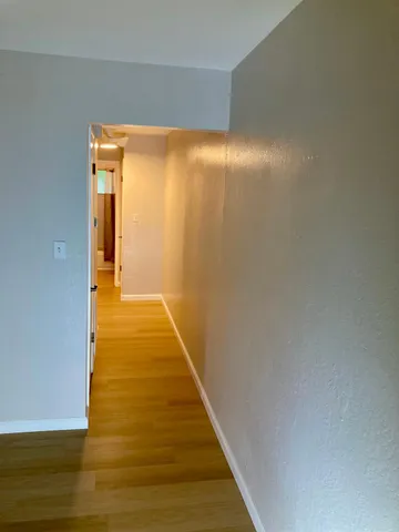 an empty room with wooden floor